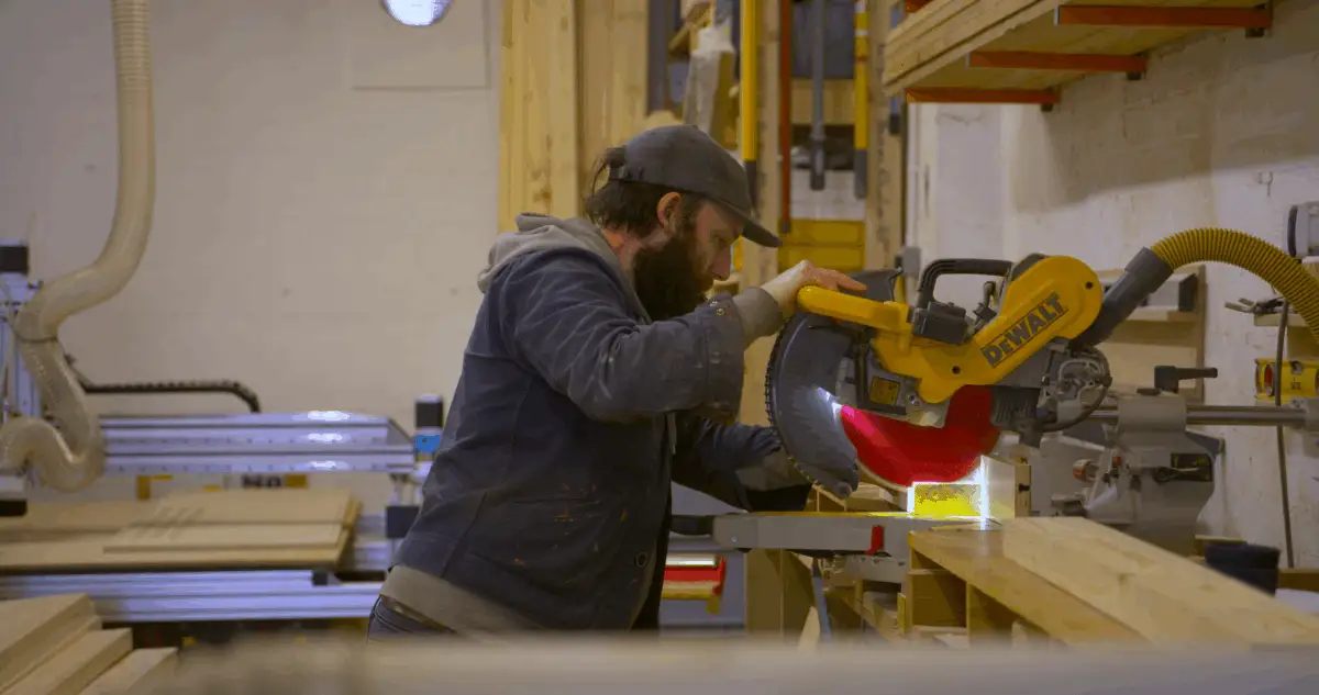 Image of workman using a saw.